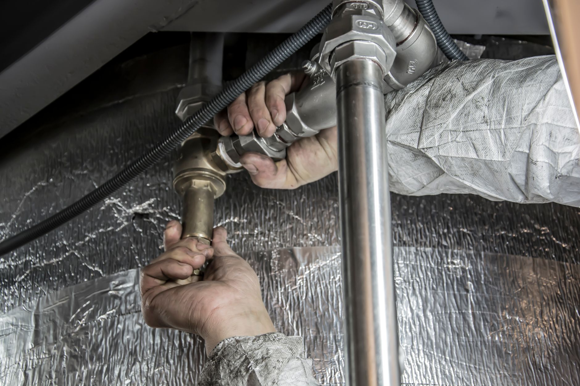 Plumber repairing a pipe